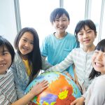 Elementary school students with globe