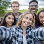 Multi_ethnic Teenagers Taking a Self Portrait stock photo