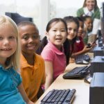 Kindergarten children learning how to use a computer